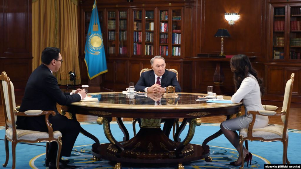 Former Kazakh President Nursultan Nazarbaev (center) made his remarks to interviewers from state TV.