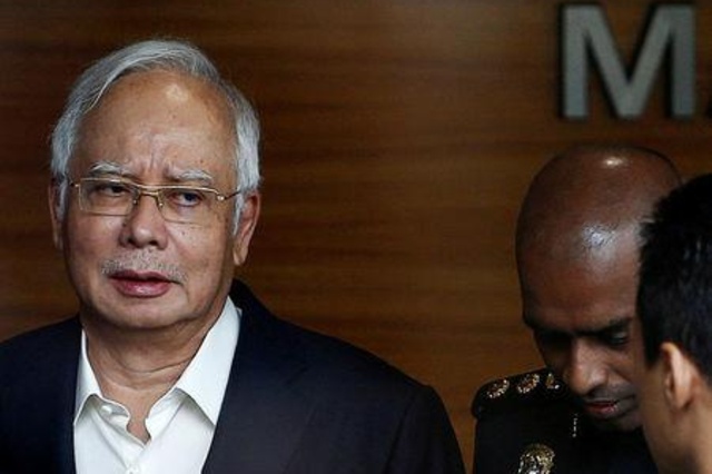 Malaysian police found $28 million in cash, 400-plus handbags in 1MDB-linked searches