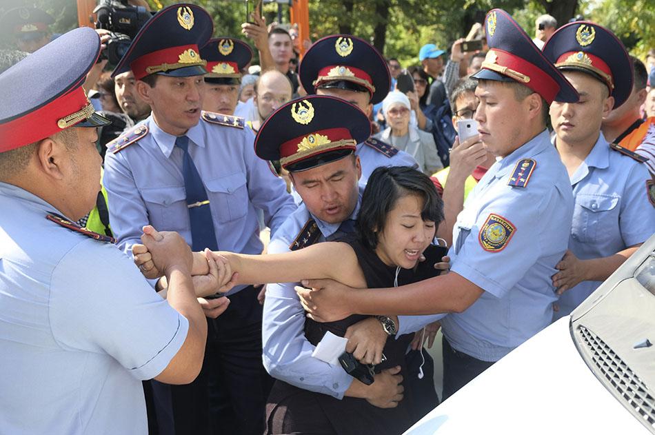 Kazakhstan police officers detain a protester during an opposition rally in Almaty, September 21, 2019. © 2019 AP Photo/Vladimir Tretyakov