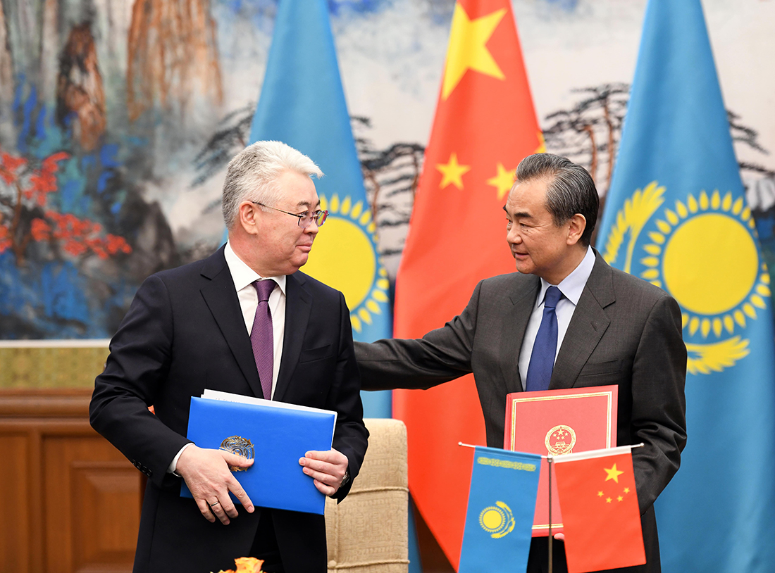 Chinese Foreign Minister Wang Yi hosts/consoles his Kazakh counterpart, Beibut Atamkulov, in Beijing on March 28. (Kazakh Foreign Ministry)