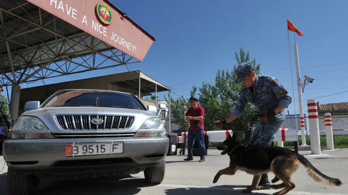 A Kyrgyz border guard checks a vehicle at the country's frontier with Uzbekistan. Central Asian states are looking for ways to ease trade and travel within the region © AFP